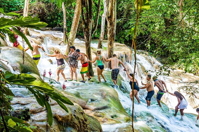 Zipline, Dunn’s River Falls, Bamboo Rafting & Horseback Ride Tour - Ziplining above the falls